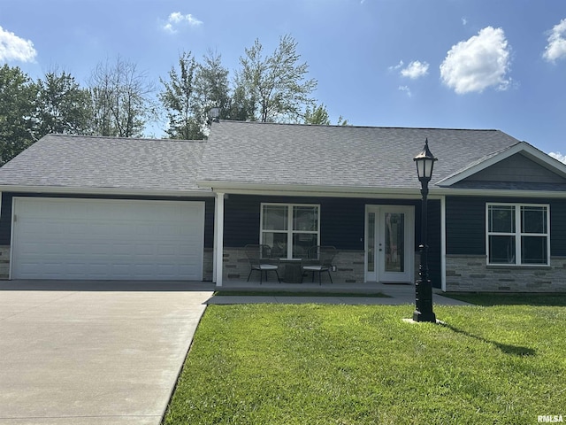 1612 N Garfield St, Marion, IL 62959 - ranch-style house with stone siding, a garage, concrete driveway, and a front lawn