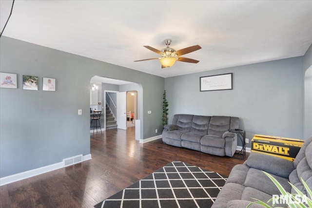 2506 N Howell St, Davenport, IA 52804 - living room featuring arched walkways, stairway, ceiling fan, and wood finished floors