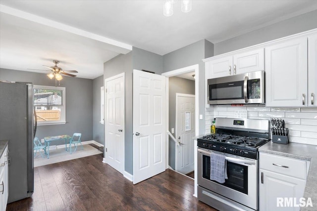 2506 N Howell St, Davenport, IA 52804 - kitchen with stainless steel appliances, decorative backsplash, white cabinetry, and dark wood-style floors