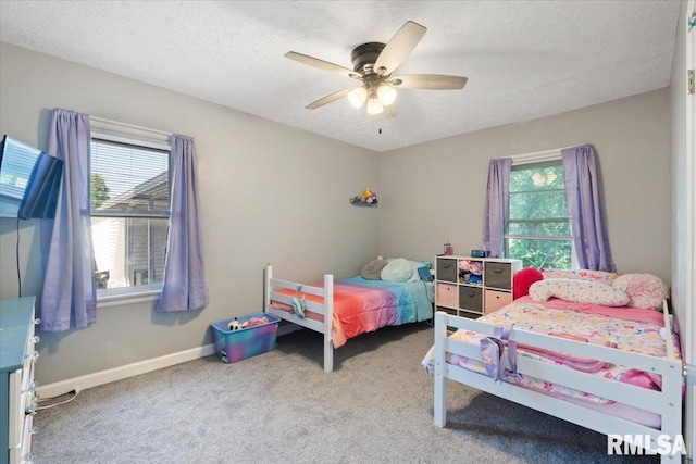 2506 N Howell St, Davenport, IA 52804 - carpeted bedroom with a textured ceiling and ceiling fan