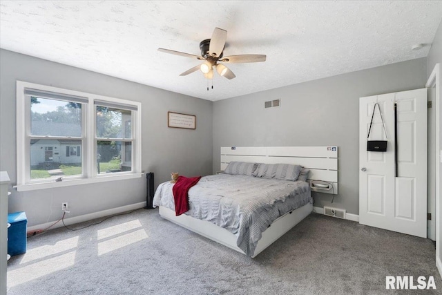 2506 N Howell St, Davenport, IA 52804 - carpeted bedroom with a textured ceiling and a ceiling fan