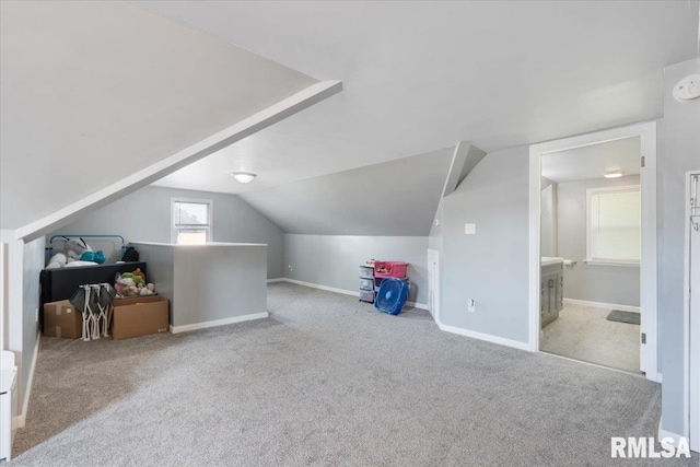 2506 N Howell St, Davenport, IA 52804 - additional living space with carpet flooring and lofted ceiling