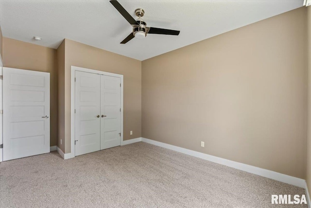 6691 Spring Creek Dr, Bettendorf, IA 52722 - unfurnished bedroom featuring light carpet, a closet, and a ceiling fan