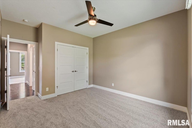 6691 Spring Creek Dr, Bettendorf, IA 52722 - unfurnished bedroom featuring carpet flooring, a closet, and ceiling fan