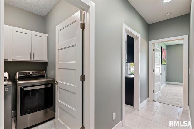 6691 Spring Creek Dr, Bettendorf, IA 52722 - washroom featuring cabinet space and washing machine and clothes dryer