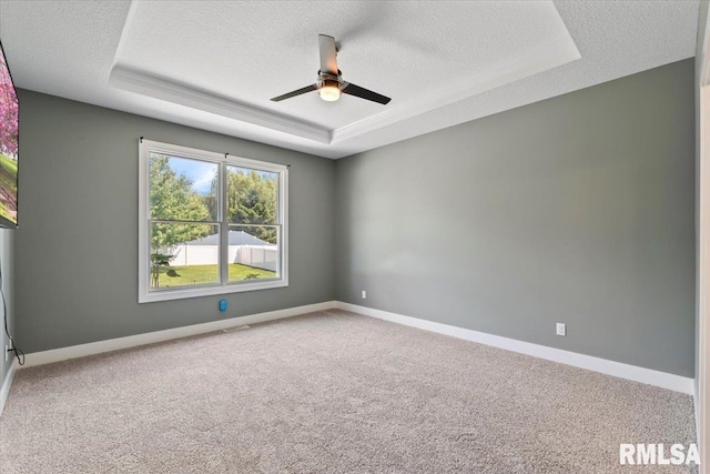 6691 Spring Creek Dr, Bettendorf, IA 52722 - empty room with a raised ceiling, a textured ceiling, ceiling fan, and carpet flooring