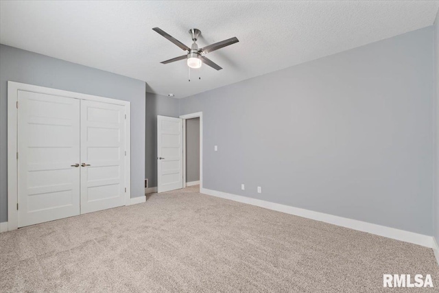 6691 Spring Creek Dr, Bettendorf, IA 52722 - unfurnished bedroom with carpet, a closet, a textured ceiling, and ceiling fan