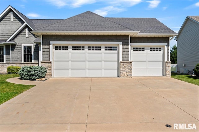 6691 Spring Creek Dr, Bettendorf, IA 52722 - craftsman-style house with stone siding, driveway, roof with shingles, and a garage