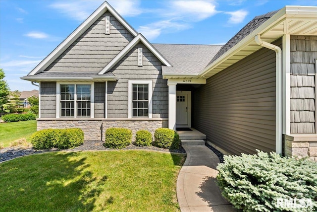 6691 Spring Creek Dr, Bettendorf, IA 52722 - view of front of house with stone siding, a front lawn, and a shingled roof