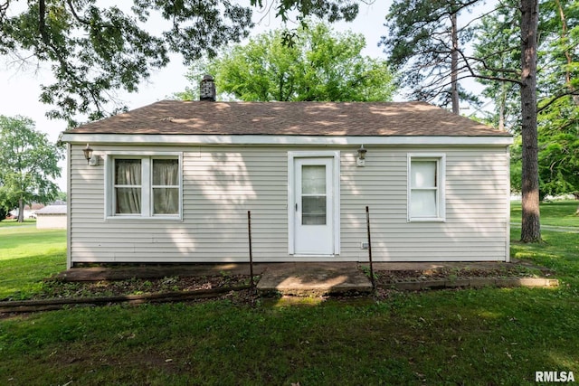 105 Laurel St, Stonefort, IL 62987 - rear view of property with a lawn, a chimney, and roof with shingles