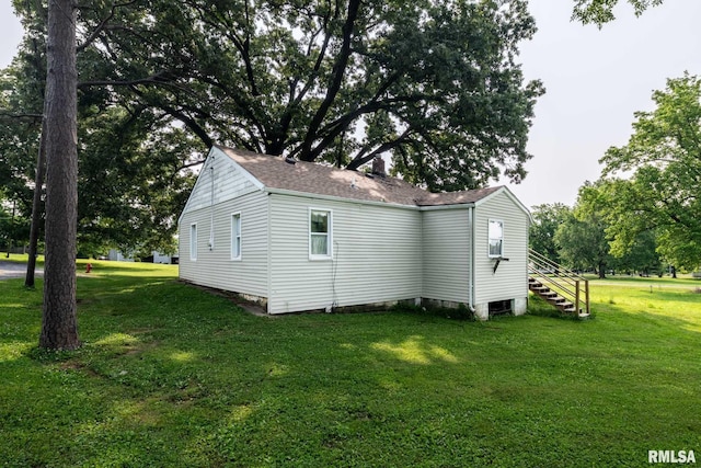 105 Laurel St, Stonefort, IL 62987 - view of property exterior with a lawn, roof with shingles, and stairway
