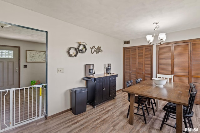 209 Hilltop St, Colona, IL 61241 - dining room featuring light wood-style flooring and a chandelier