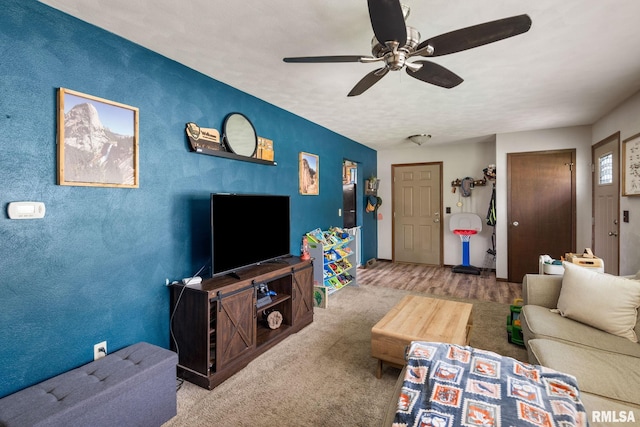 209 Hilltop St, Colona, IL 61241 - carpeted living room with ceiling fan and baseboards
