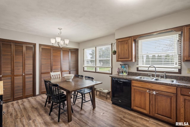 209 Hilltop St, Colona, IL 61241 - kitchen featuring black dishwasher, dark countertops, a chandelier, and wood finished floors