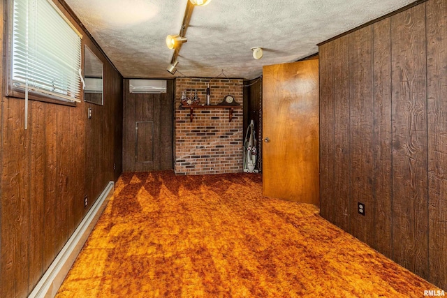 2305 Weaver Rd, Herrin, IL 62948 - carpeted empty room featuring wooden walls, a textured ceiling, a wall mounted AC, brick wall, and a baseboard heating unit
