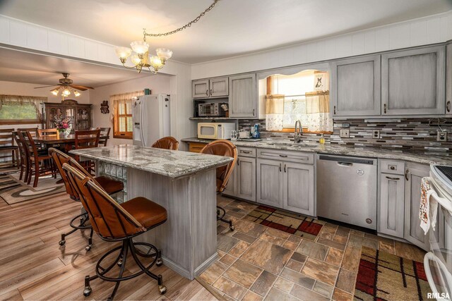 2305 Weaver Rd, Herrin, IL 62948 - kitchen with white appliances, gray cabinetry, healthy amount of natural light, and tasteful backsplash