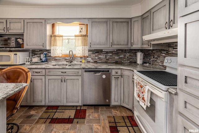 2305 Weaver Rd, Herrin, IL 62948 - kitchen with white appliances, under cabinet range hood, backsplash, dark stone finish flooring, and gray cabinets