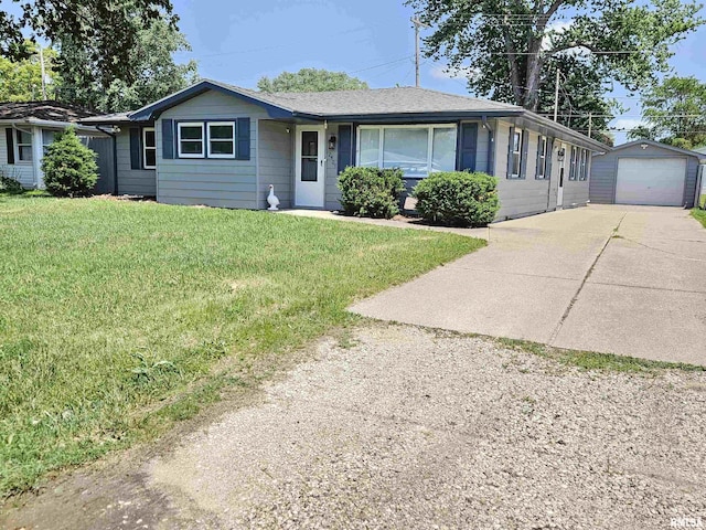 2409 9th St, Silvis, IL 61282 - single story home with concrete driveway, an outbuilding, a front lawn, and a garage