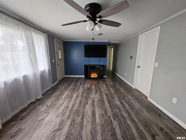 2409 9th St, Silvis, IL 61282 - unfurnished living room featuring ceiling fan, a lit fireplace, wood finished floors, and ornamental molding