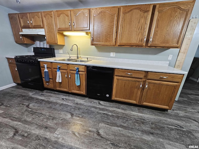 2409 9th St, Silvis, IL 61282 - kitchen featuring black appliances, under cabinet range hood, dark wood-type flooring, light countertops, and brown cabinets