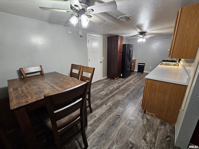 2409 9th St, Silvis, IL 61282 - dining area featuring a ceiling fan and dark wood-style flooring