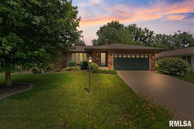 5315 34th Ave, Moline, IL 61265 - view of front facade with an attached garage, driveway, a front lawn, a chimney, and brick siding