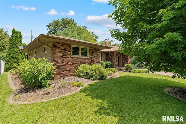 5315 34th Ave, Moline, IL 61265 - ranch-style home featuring a chimney, a front yard, and brick siding