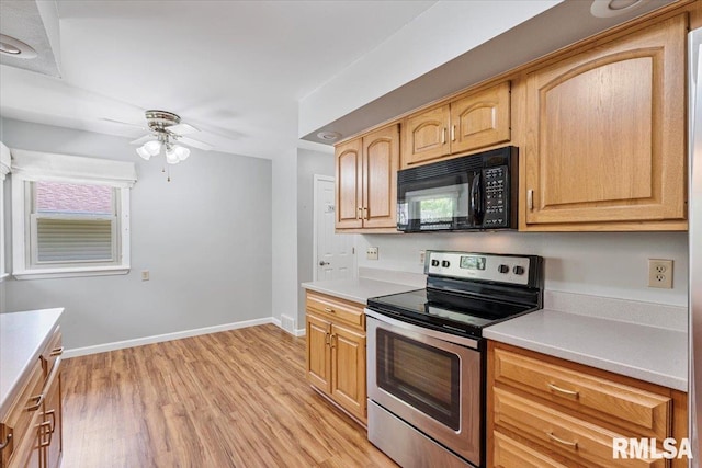 5315 34th Ave, Moline, IL 61265 - kitchen with black microwave, electric range, ceiling fan, and light countertops
