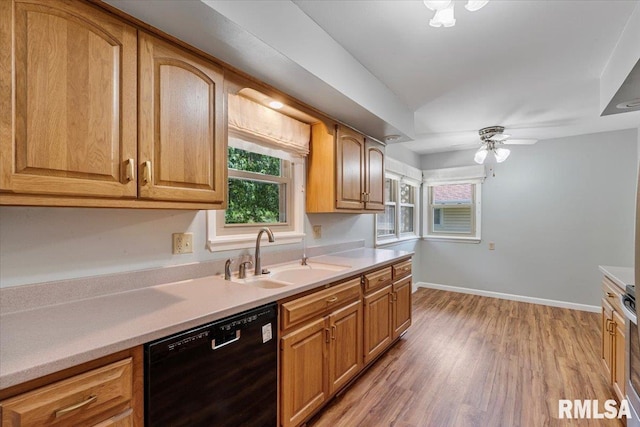 5315 34th Ave, Moline, IL 61265 - kitchen with black dishwasher, light wood-style flooring, light countertops, and plenty of natural light