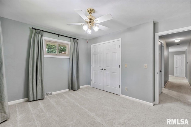 5315 34th Ave, Moline, IL 61265 - unfurnished bedroom with light colored carpet, a closet, and a ceiling fan