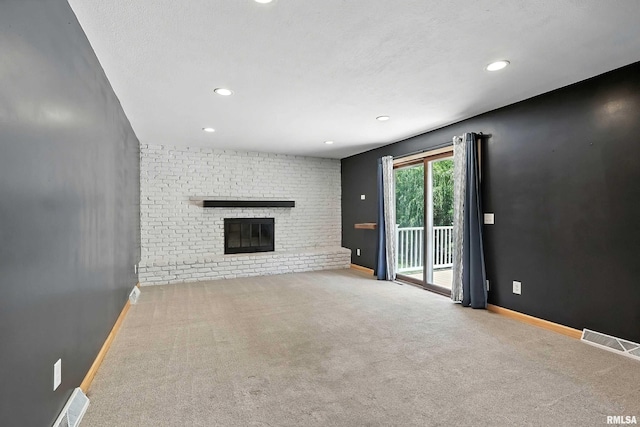 4345 Amesbury Dr, Bettendorf, IA 52722 - unfurnished living room featuring carpet, a brick fireplace, and recessed lighting