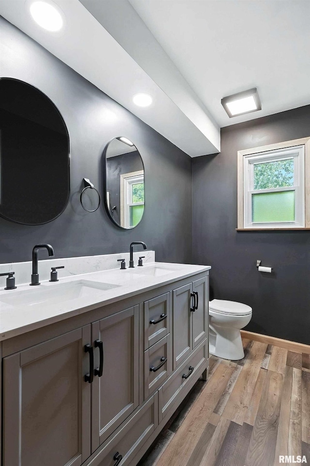 4345 Amesbury Dr, Bettendorf, IA 52722 - full bathroom featuring double vanity and wood finished floors