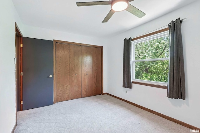 4345 Amesbury Dr, Bettendorf, IA 52722 - unfurnished bedroom featuring carpet, a closet, and ceiling fan