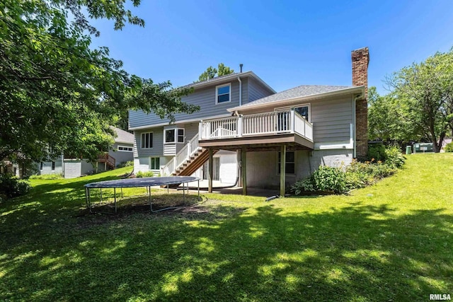 4345 Amesbury Dr, Bettendorf, IA 52722 - back of house featuring a wooden deck, a trampoline, stairway, a chimney, and a yard