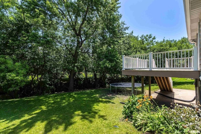 4345 Amesbury Dr, Bettendorf, IA 52722 - view of green lawn featuring a trampoline, stairs, and a deck