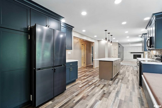 4345 Amesbury Dr, Bettendorf, IA 52722 - kitchen featuring freestanding refrigerator, stainless steel electric stove, a center island, recessed lighting, and light countertops