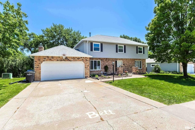4345 Amesbury Dr, Bettendorf, IA 52722 - view of front of property with an attached garage, a front yard, brick siding, and driveway