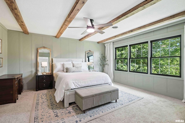 1200 Bridgeview Place, Le Claire, IA 52753 - bedroom with beam ceiling, a decorative wall, light carpet, and ceiling fan