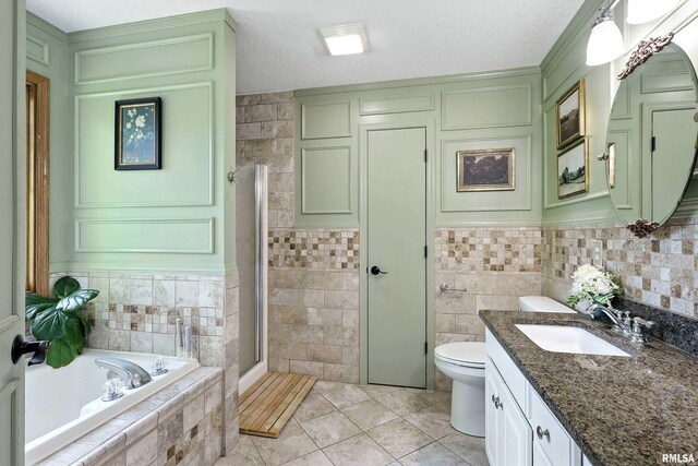 1200 Bridgeview Place, Le Claire, IA 52753 - full bathroom featuring vanity, a bath, a shower stall, tile patterned flooring, and tile walls