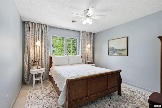 1200 Bridgeview Place, Le Claire, IA 52753 - bedroom featuring a textured ceiling, ceiling fan, and light carpet