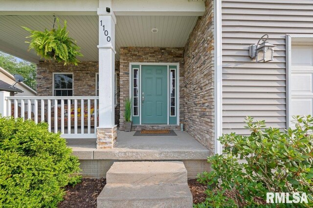 1100 Wild W Dr, Le Claire, IA 52753 - entrance to property with a porch and stone siding