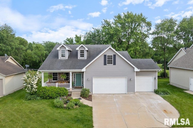 1100 Wild W Dr, Le Claire, IA 52753 - view of front of home featuring covered porch, concrete driveway, a front lawn, and a garage