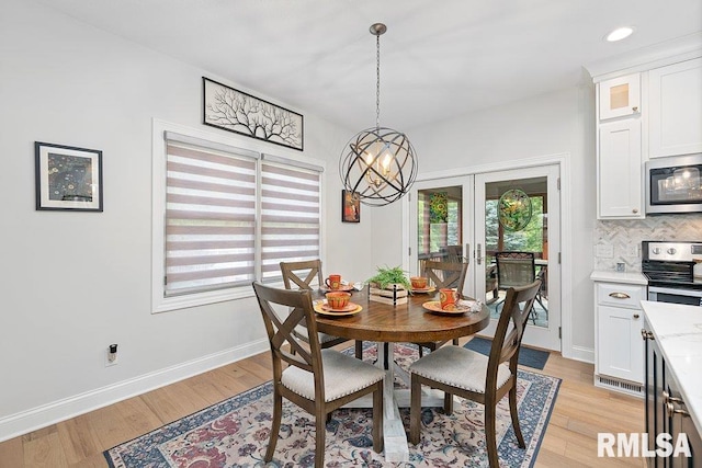 1100 Wild W Dr, Le Claire, IA 52753 - dining area with a chandelier, french doors, healthy amount of natural light, light wood-style flooring, and recessed lighting