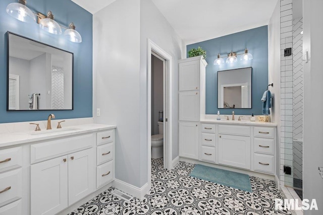 1100 Wild W Dr, Le Claire, IA 52753 - bathroom featuring two vanities and tile patterned floors