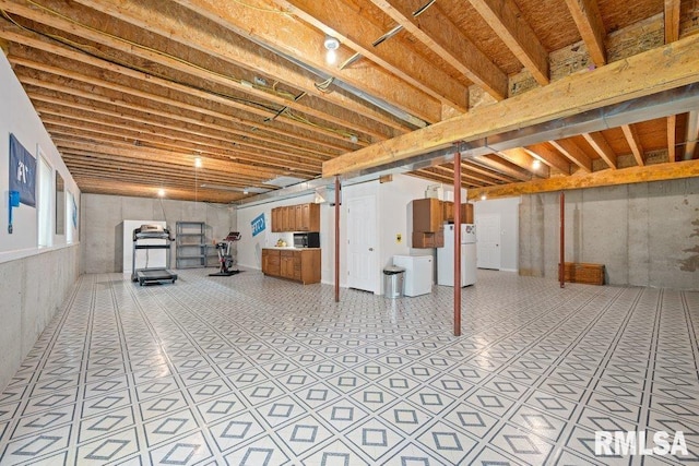 1100 Wild W Dr, Le Claire, IA 52753 - basement with freestanding refrigerator