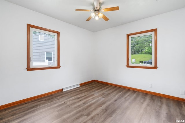 612 Waverly Rd, Davenport, IA 52804 - spare room with wood finished floors, a baseboard heating unit, and a ceiling fan