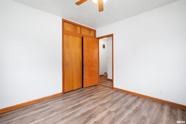 612 Waverly Rd, Davenport, IA 52804 - unfurnished bedroom featuring light wood-style floors, a closet, and a ceiling fan