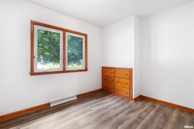 612 Waverly Rd, Davenport, IA 52804 - empty room featuring a baseboard heating unit and light wood-type flooring