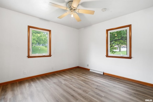 612 Waverly Rd, Davenport, IA 52804 - empty room with wood finished floors, a smoke detector, and a ceiling fan