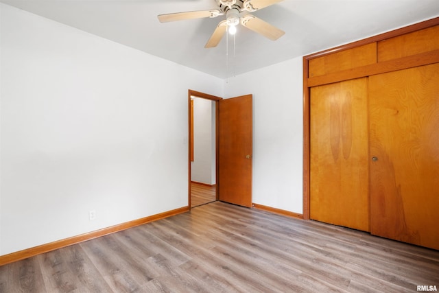 612 Waverly Rd, Davenport, IA 52804 - unfurnished bedroom with light wood-type flooring, a closet, and a ceiling fan